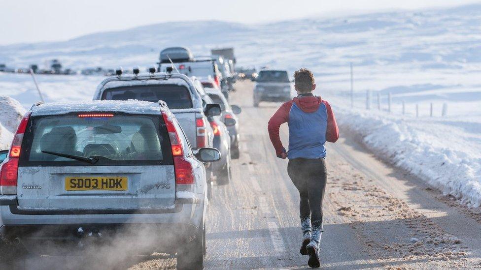 Man running along road at Glencoe