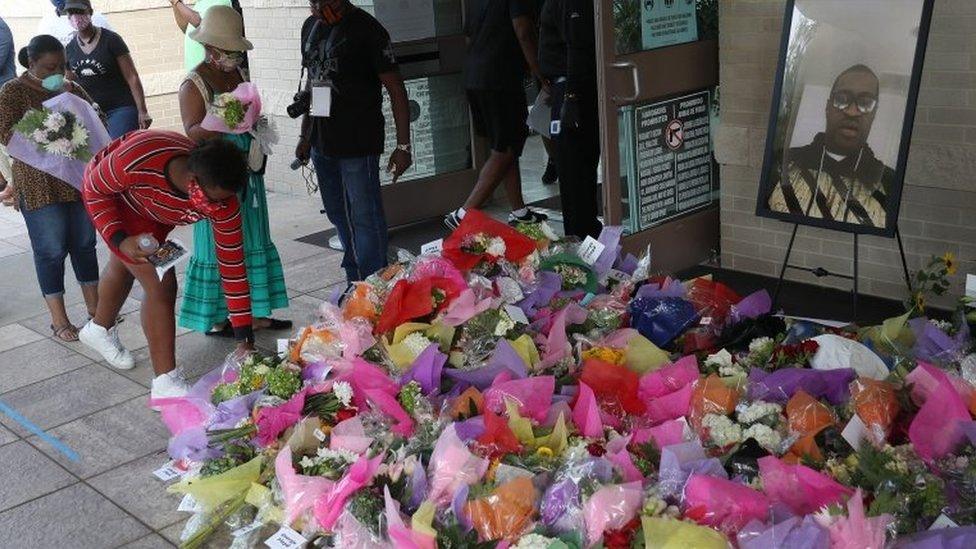 People-lay-flowers-outside-church.