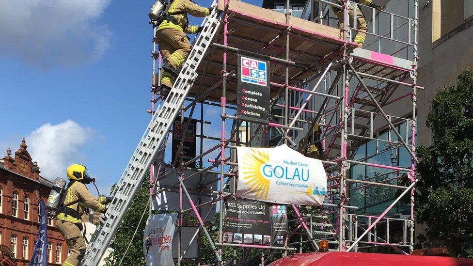 Picture of the firefighters climbing the ladder