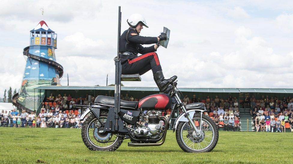 A member of the White Helmets, the Royal Signals Motorcycle Display Team