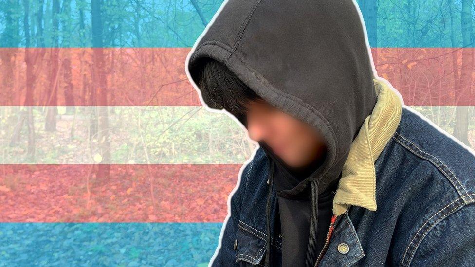 Trans man wearing hood