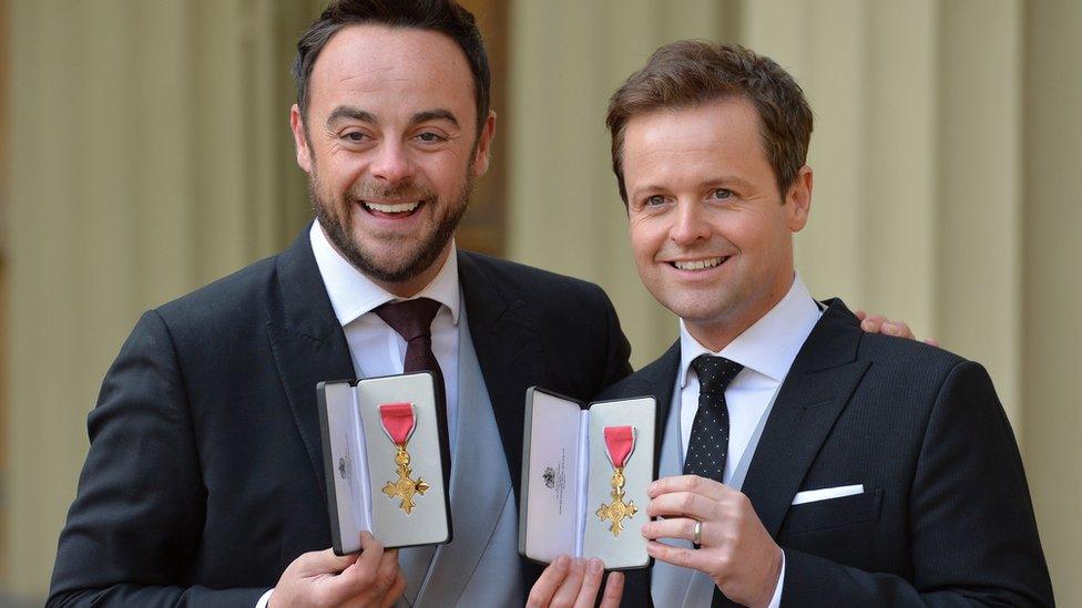 ant and dec smiling holding their obes