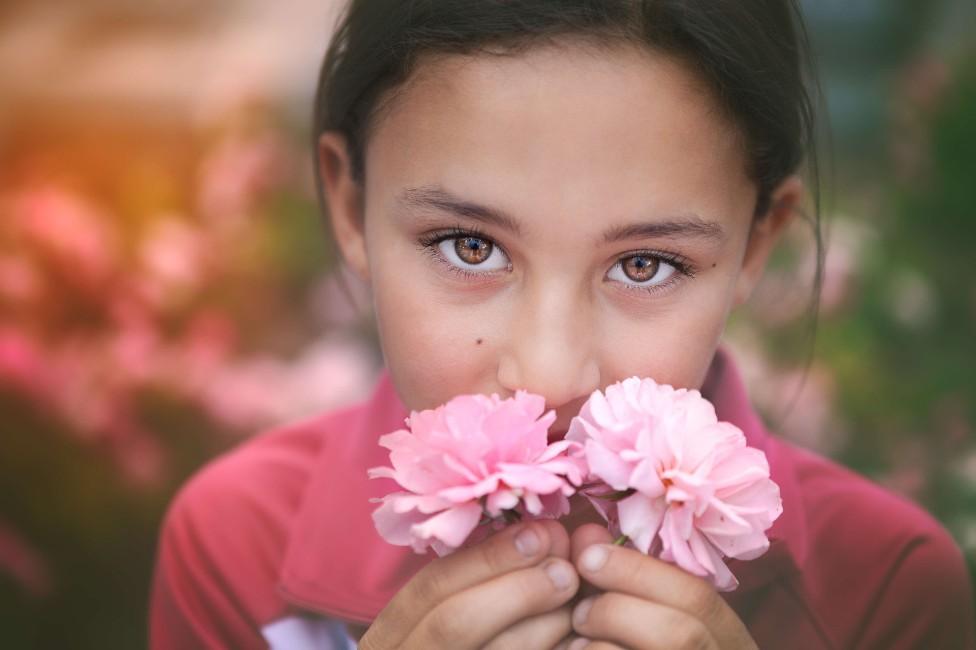 Girl smelling roses