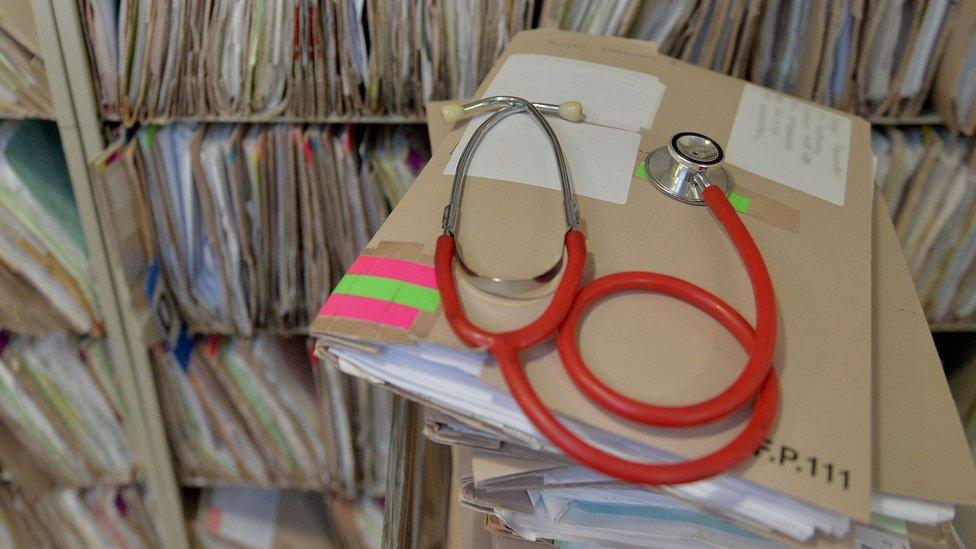 Stethoscope on top of patient files