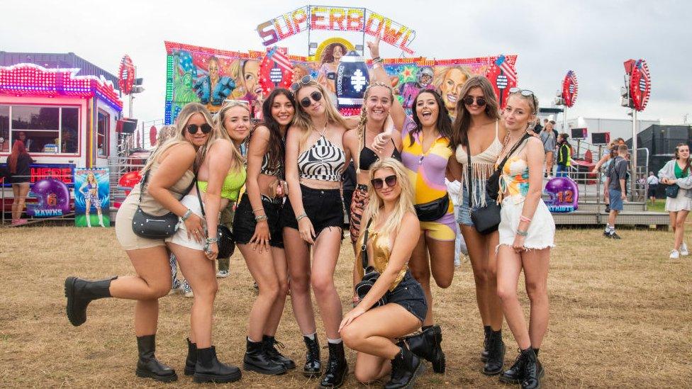 Festivalgoers enjoy the festival grounds as part of the Arena opens up at Reading Festival on August 25, 2022