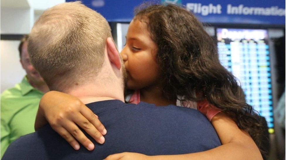 Daughter kisses her father on the cheek