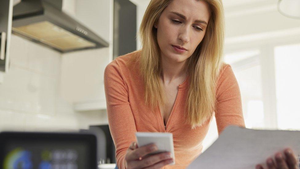 Woman looking at energy bill