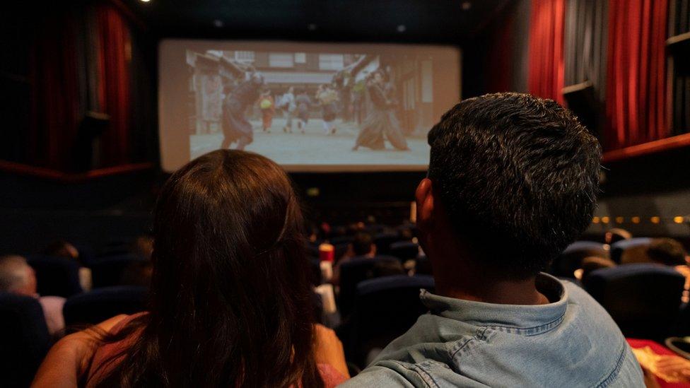 Cinema with a couple viewing big screen