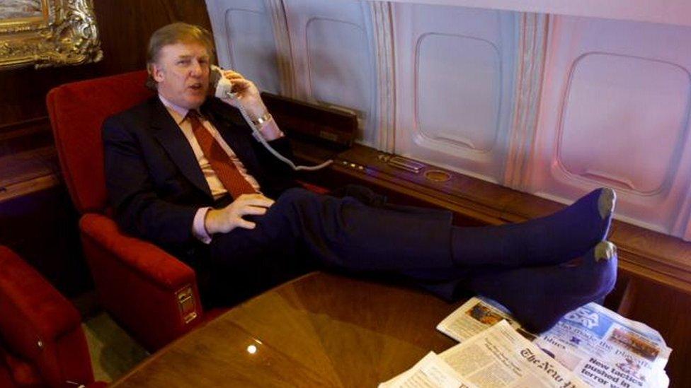 Donald Trump taking a call on his private plane in 2000