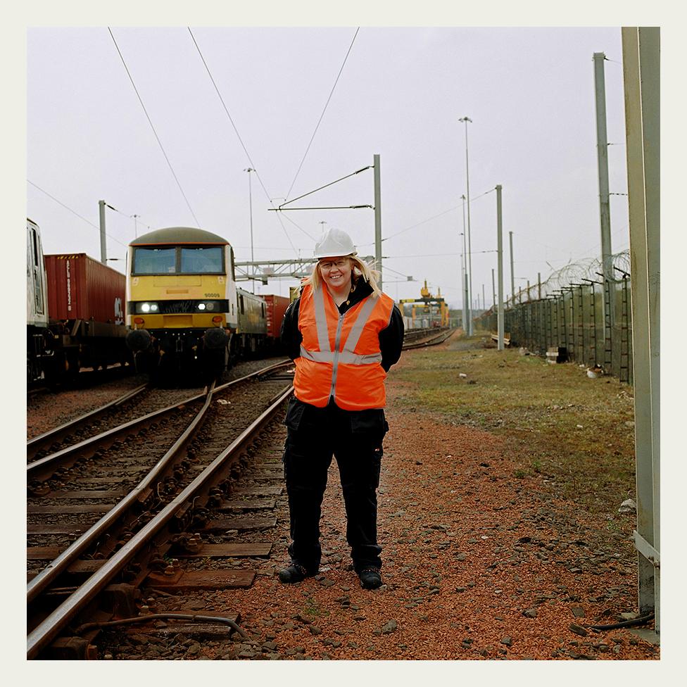 Heather Waugh, stands in front a Class 90 locomotive, at the start of her shift