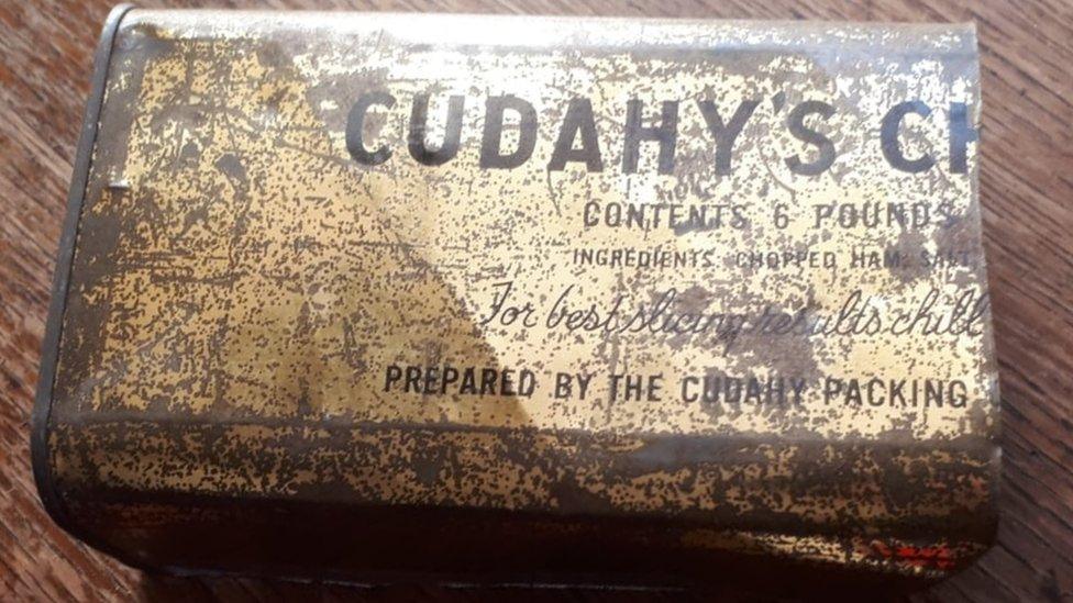 Tarnished tin container bearing the name Cudahy's