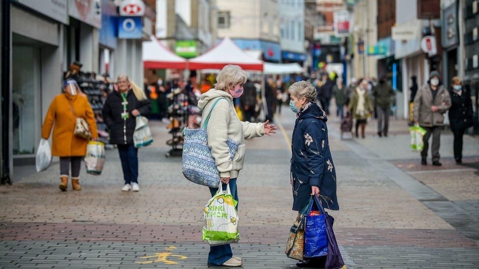 Shoppers on high street in masks