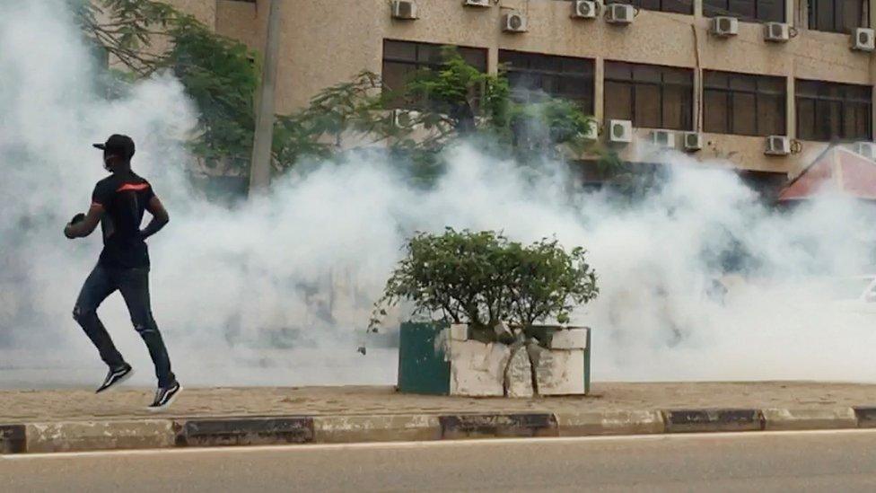 People run during a protest in Abuja, Nigeria, October 9, 2020