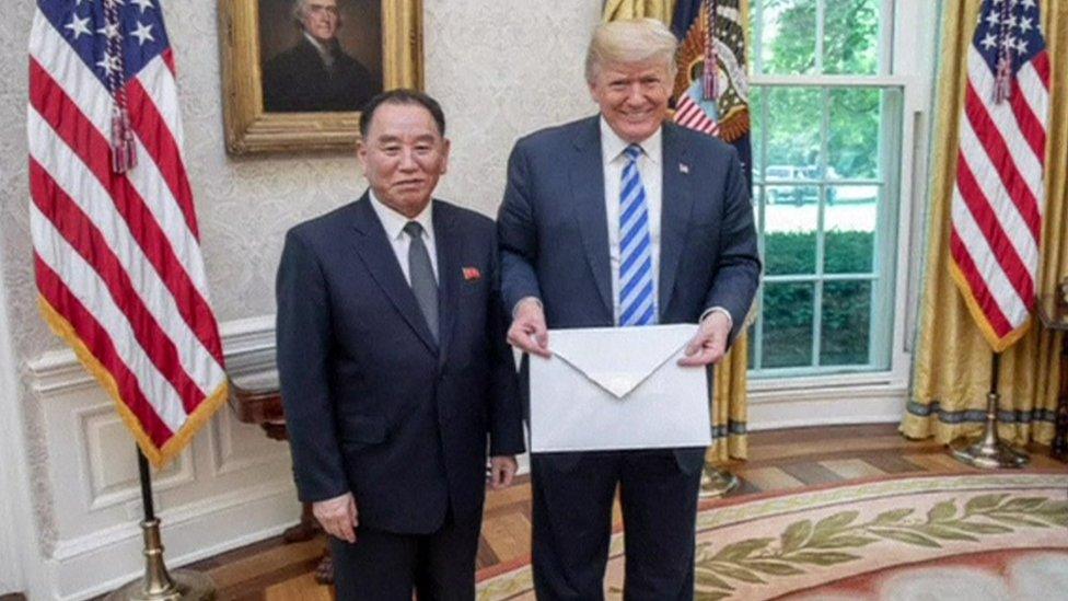 Donald Trump and North Korea's Kim Yong Chol stand with the letter