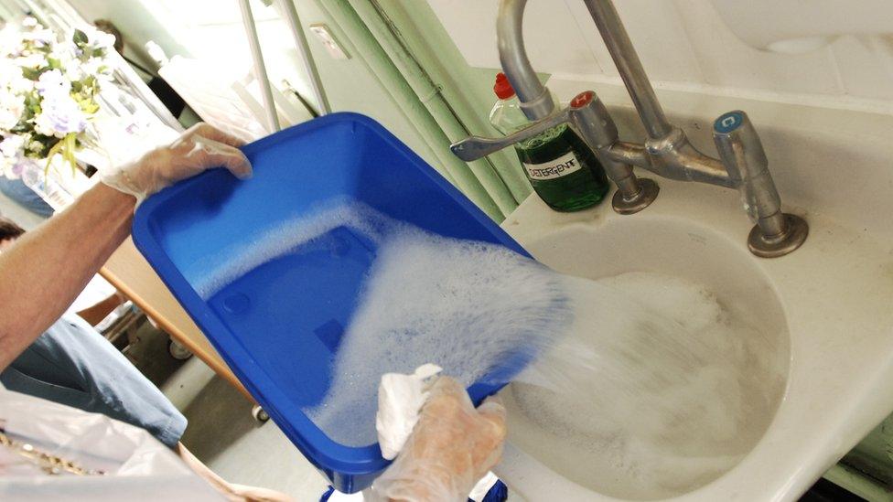 Person emptying water into sink