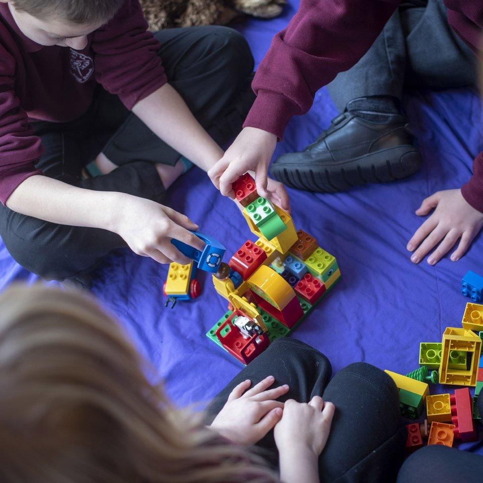 The children taking it in turns to build a model