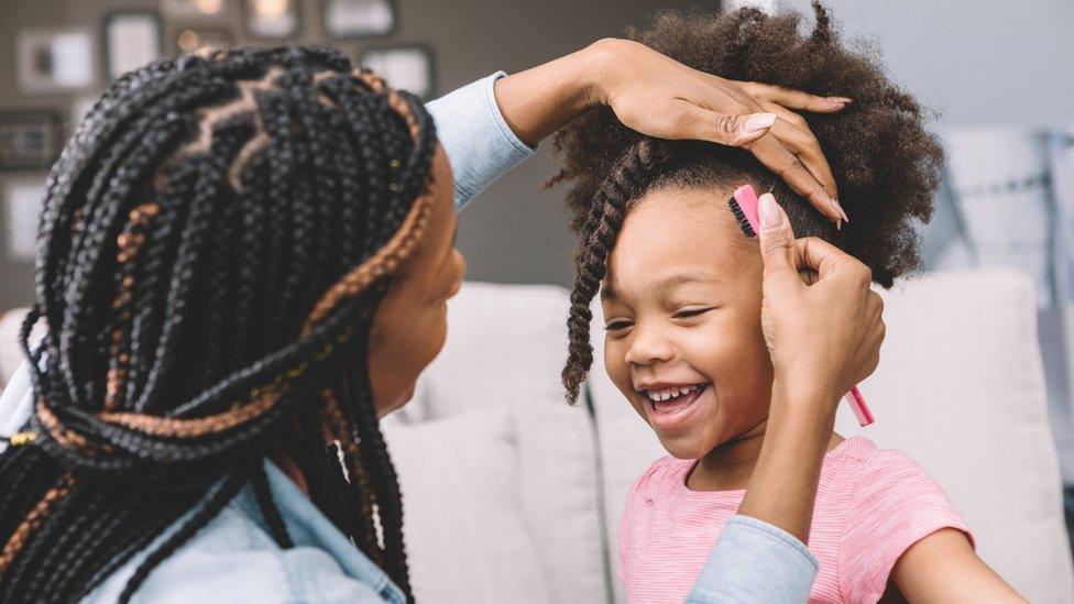 mum-styling-daughter's hair.