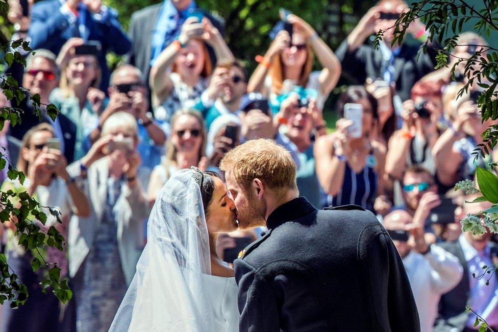 Meghan Markle and Prince Harry kiss on the steps of St George's Chapel