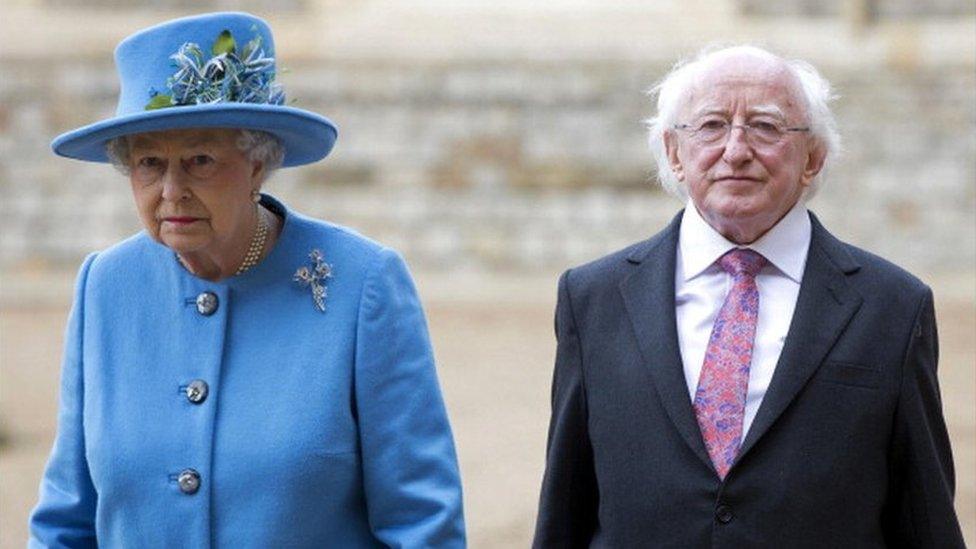 Britain's Queen Elizabeth II and Irish President Michael D. Higgins (R) walk together during a ceremonial welcome at Windsor Castle in Windsor, west of London on April 8, 2014