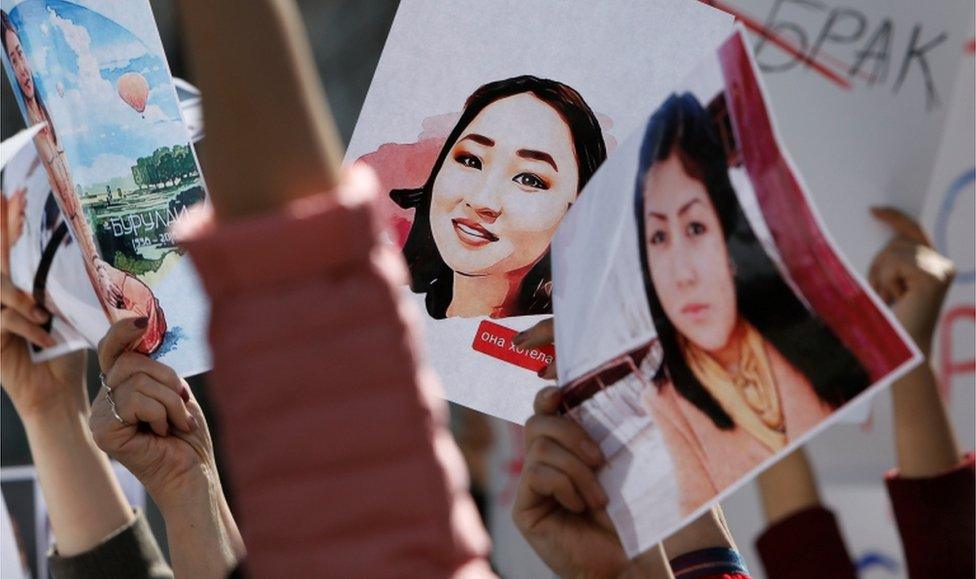 People attend a rally in front of Kyrgyzstan's interior ministry demanding the resignation of its leadership