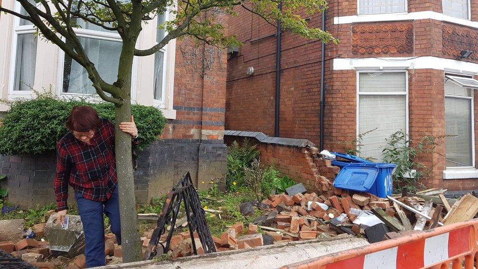 Angela Verdun outside her damaged house