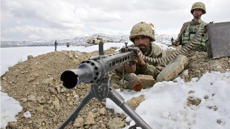 Pakistani army soldiers take position in the snow covered mountainous region of Alwara Mandei in North Waziristan along the Pakistan-Afghanistan border, 17 February 2007.