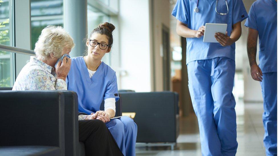 Nurse talking to a women about her illness