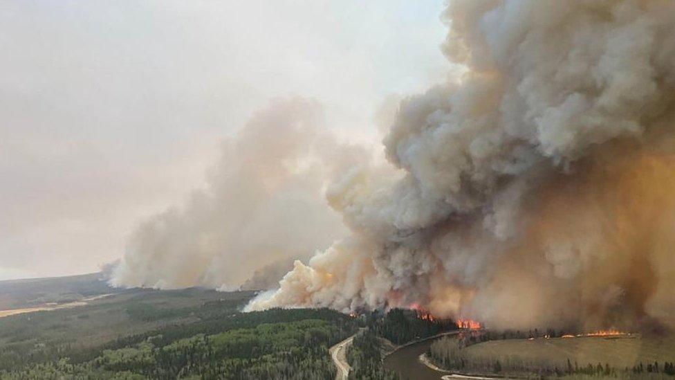 A smoke column rises from wildfire EWF-035 near Shining Bank, Alberta, Canada May 5, 2023.