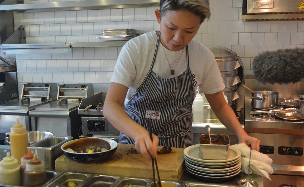 May Chow working in her kitchen