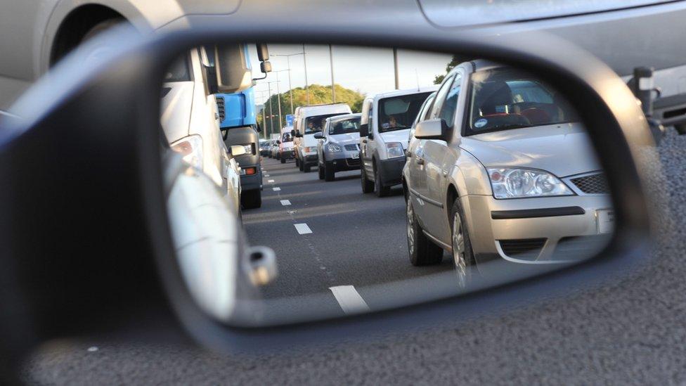 Traffic as seen in side mirror