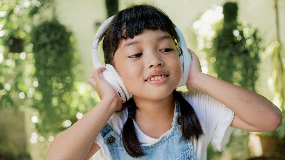 Girl listening to music in headphones