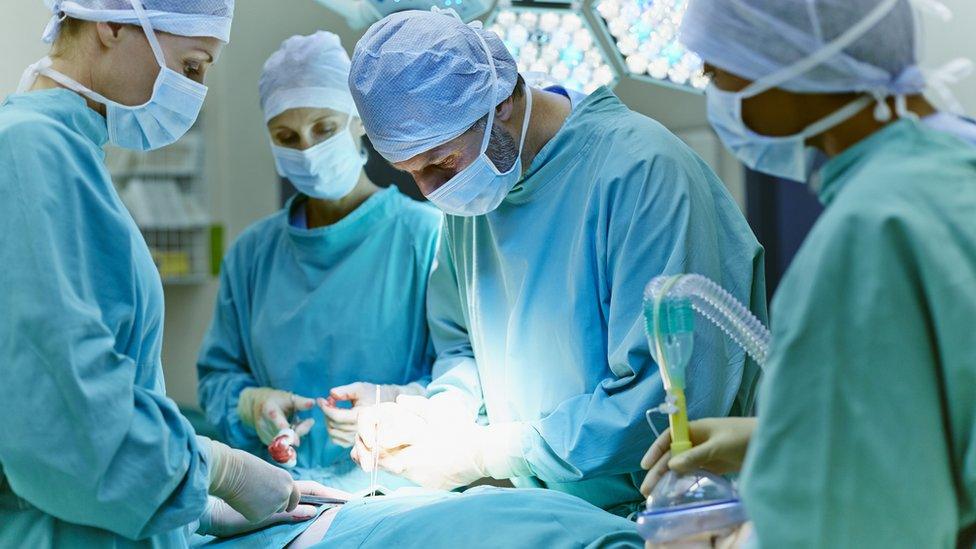 Surgeons operating