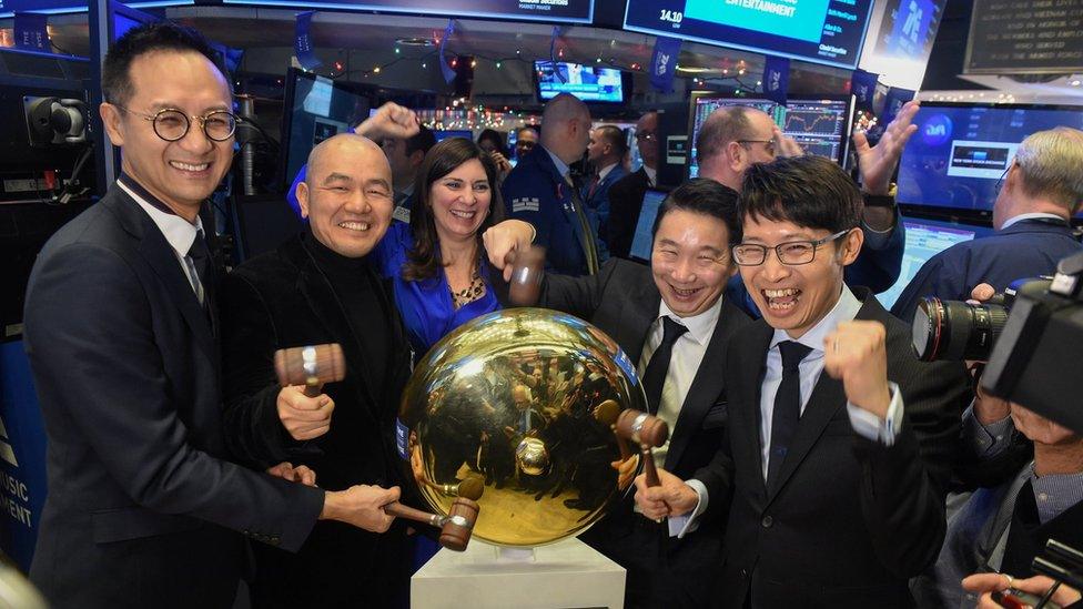 Cussion Kar Shun Pang, CEO of Tencent Music Entertainment with the company's leadership team rings a ceremonial bell to celebrate company's IPO on the floor of the New York Stock Exchange (NYSE) in New York, U.S., December 12, 2018. REUTERS/Bryan R Smith