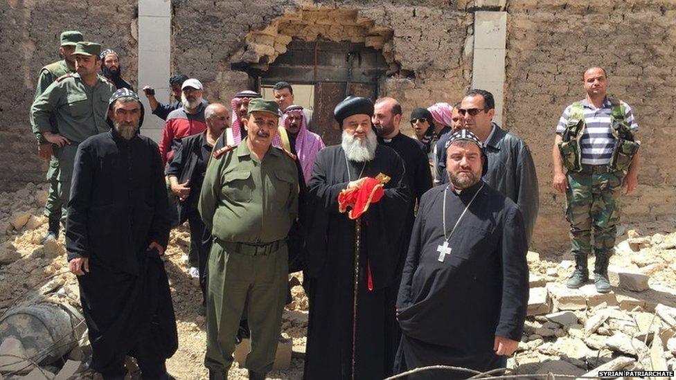 Patriarch Ignatius Aphrem II, the head of the Syrian Orthodox Church, (holding crucifix) visits al-Qaryatain on 8 April 2015