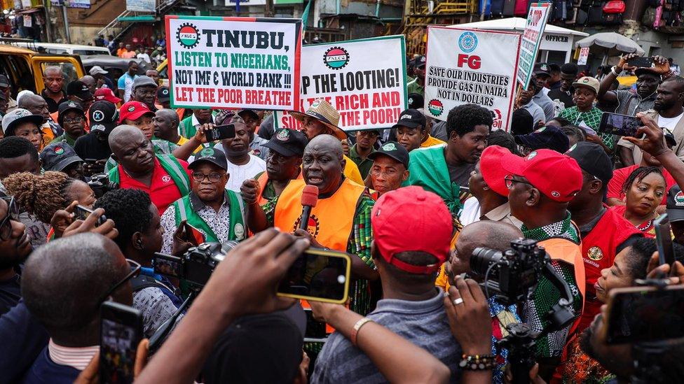 Protesters holding up placards