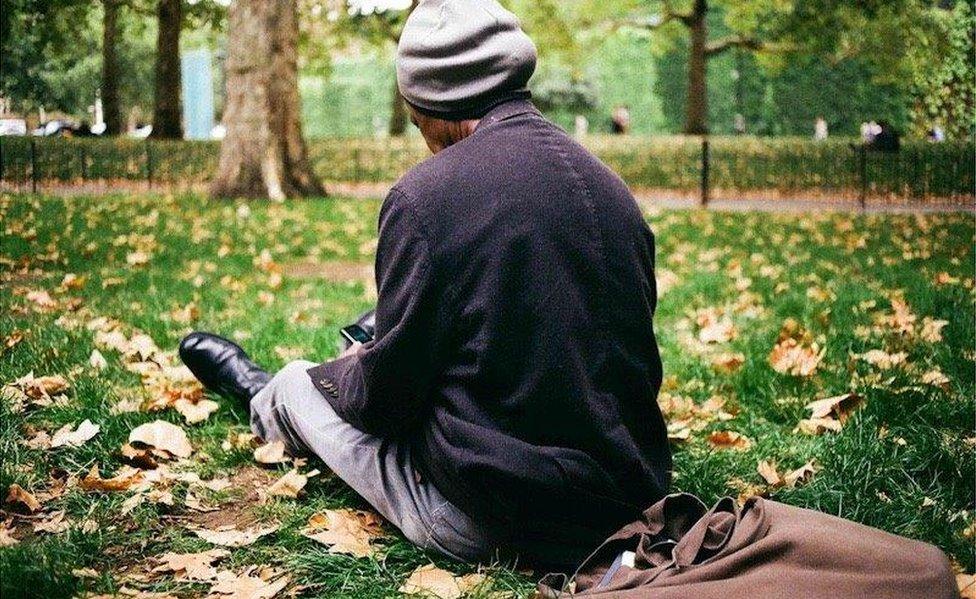 Sunny relaxes in St James's Park, with his tote bag behind him