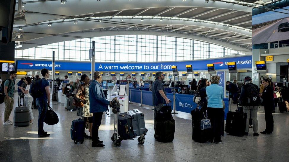 People queuing at Heathrow Airport