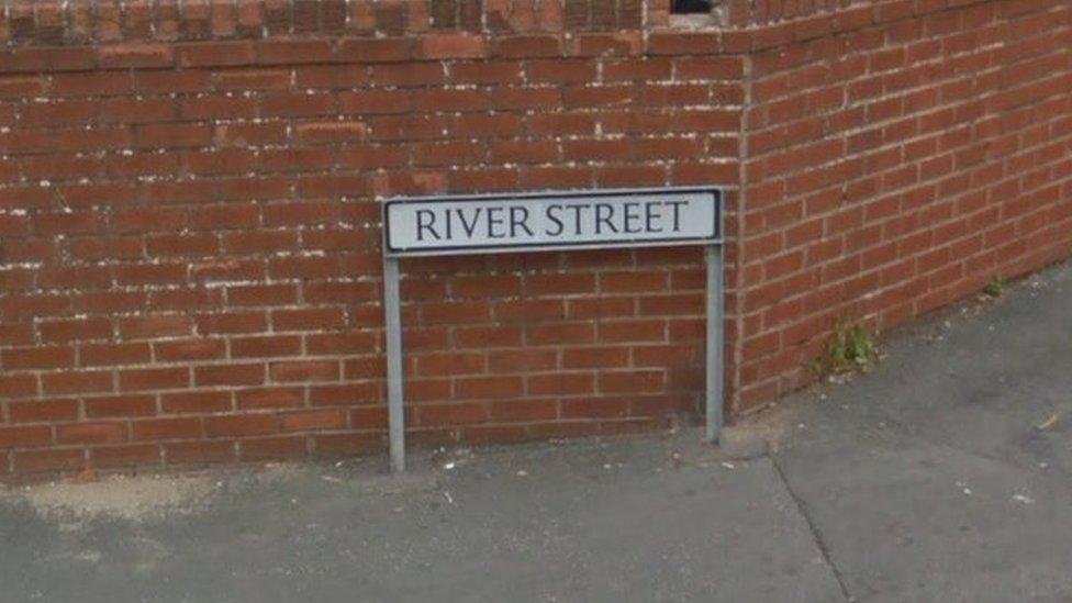 A street sign reading River Street