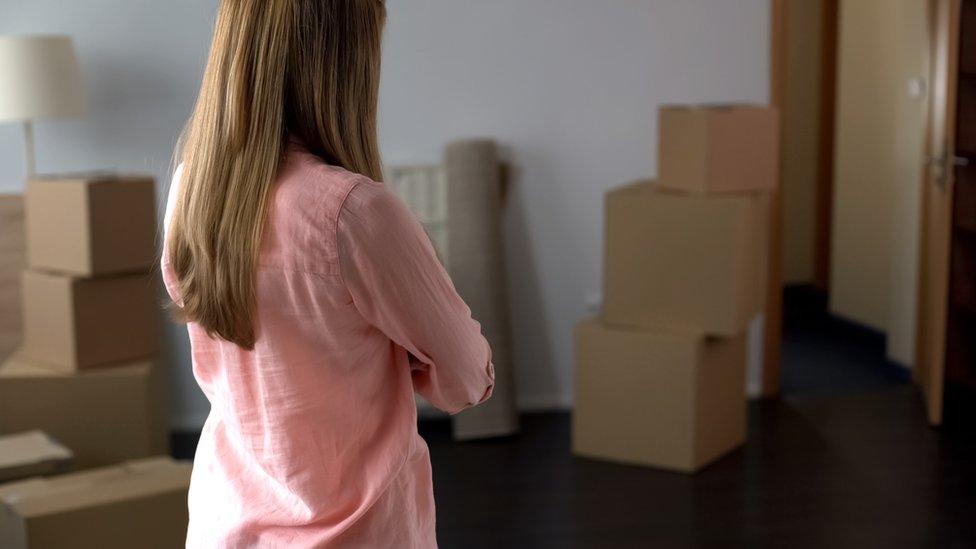 woman standing next to boxes