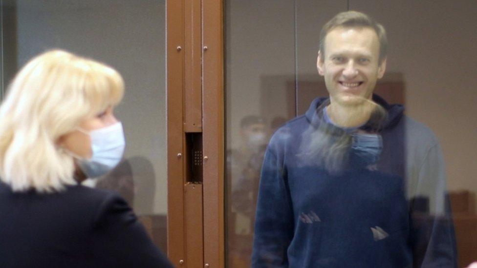 Russian opposition leader Alexei Navalny inside a glass cage prior to a hearing of a case on slander charges in Moscow, Russia, 16 Feb