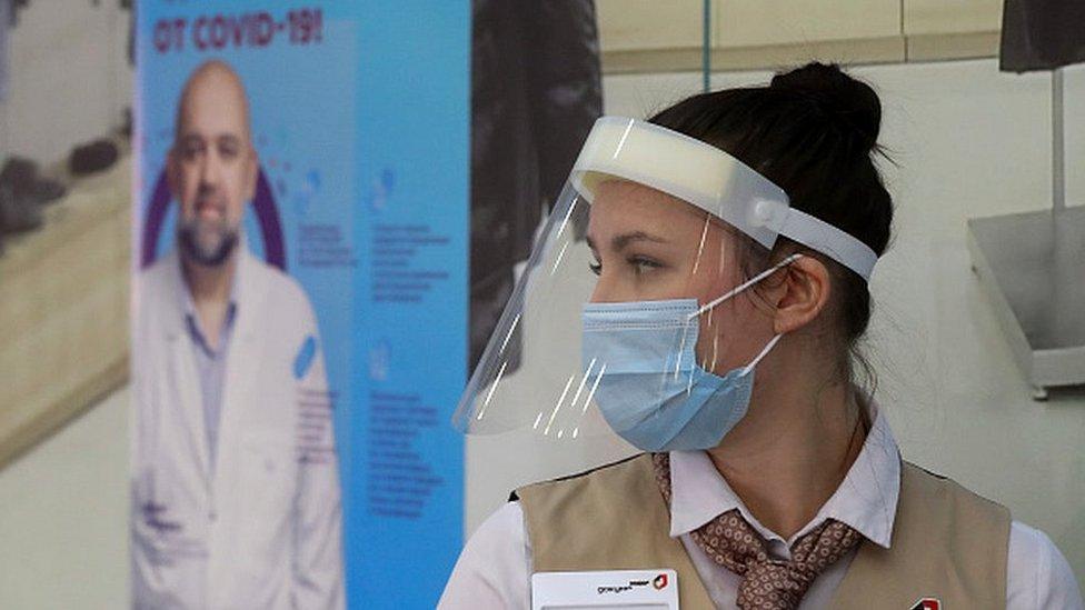 A staff member at the entrance to a temporary Covid-19 vaccination site in the Gagarinsky shopping and leisure centre