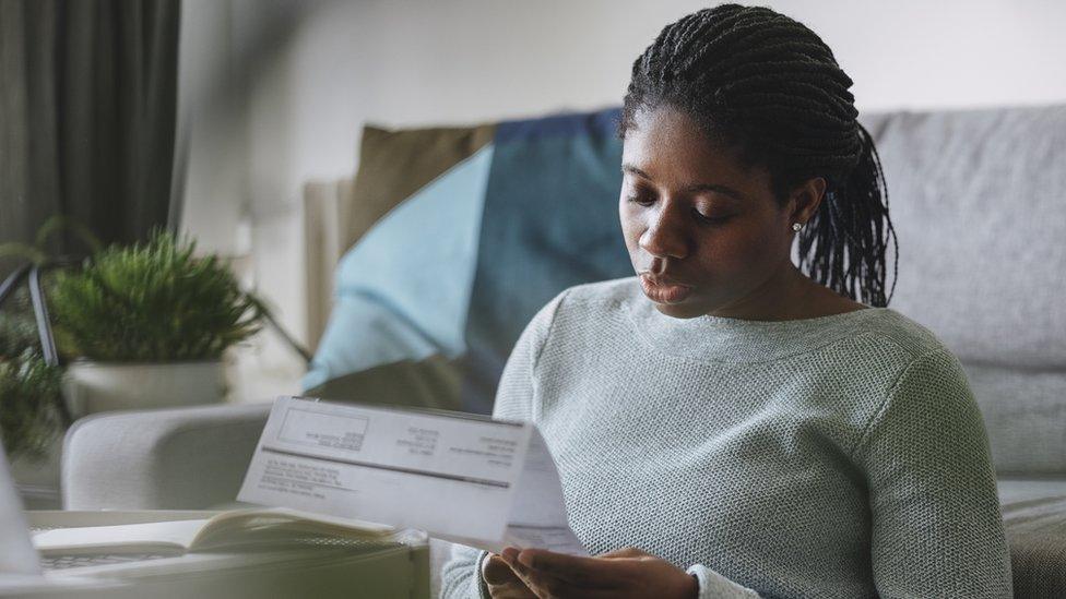 A woman reading her utility bill