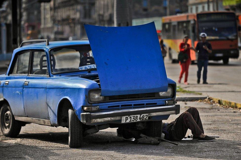 Man fixing car