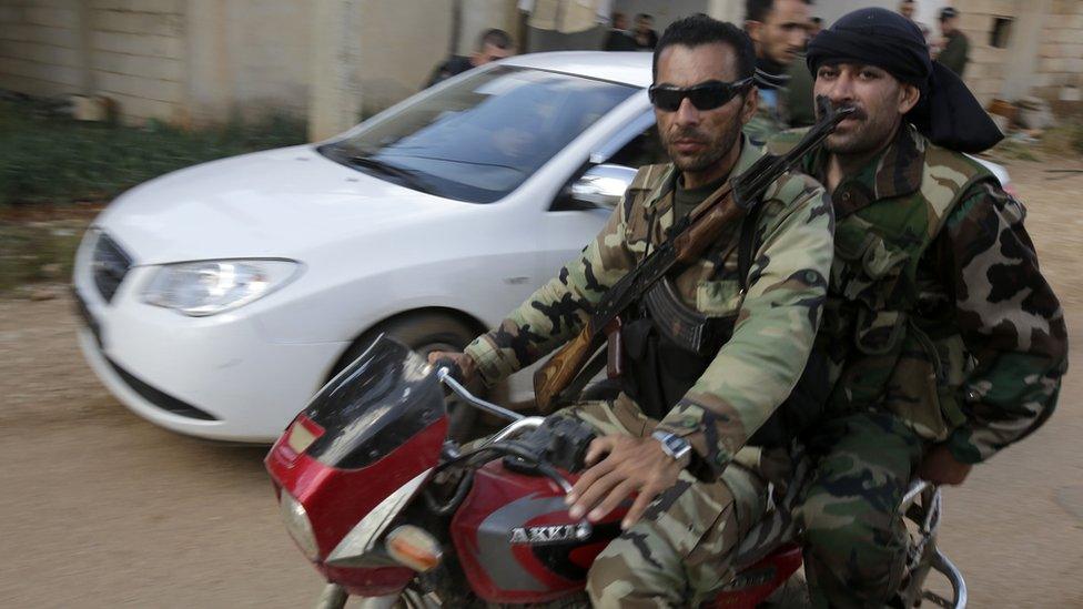 Members of the paramilitary National Defence Forces outside Qusair, Syria (11 May 2013)