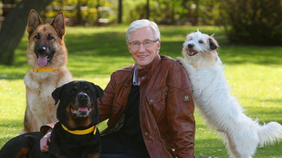 Paul O'Grady with rescue dogs Razor a German Shepherd, Moose a Rottweiler and Dodger a Terrier at London's Battersea Park