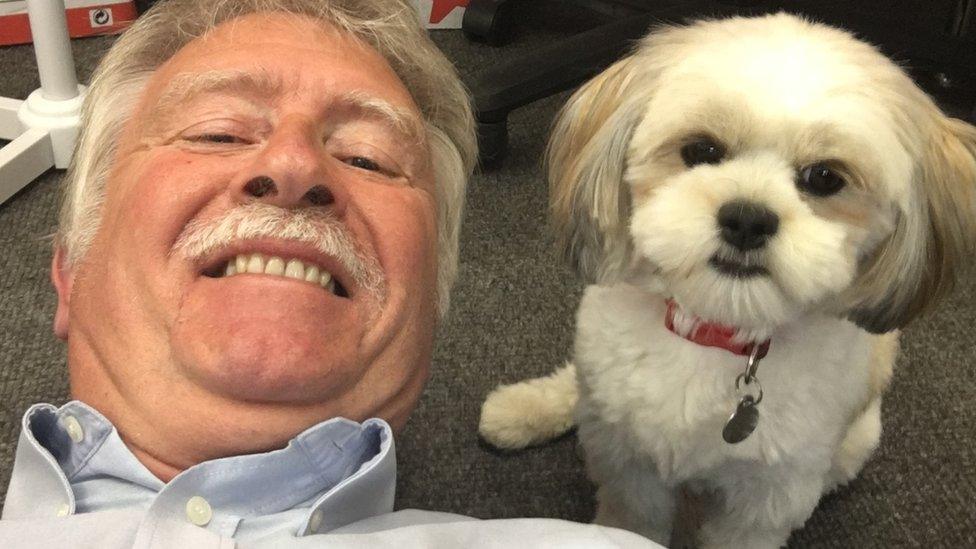 Bernard lying on the floor to take a 'selfie' with Pippa