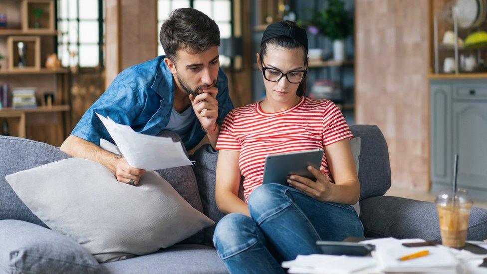 Couple look at tablet computer - stock shot