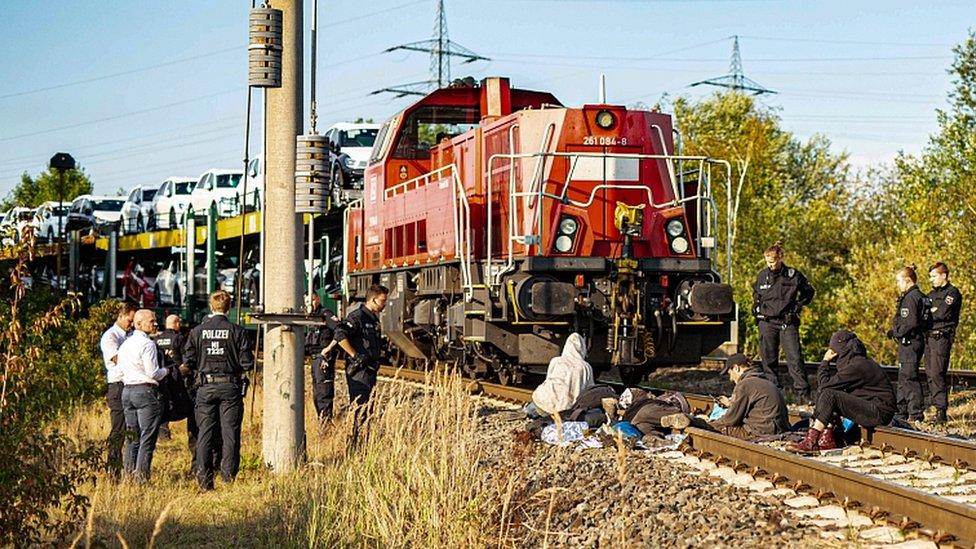 Environmentalists block railway tracks and stop a train loaded with new Volkswagen cars that has left the Volkswagen plant in Wolfsburg, northern Germany, on August 13, 2019