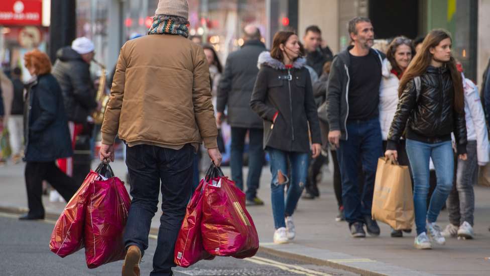 man with carrier bags