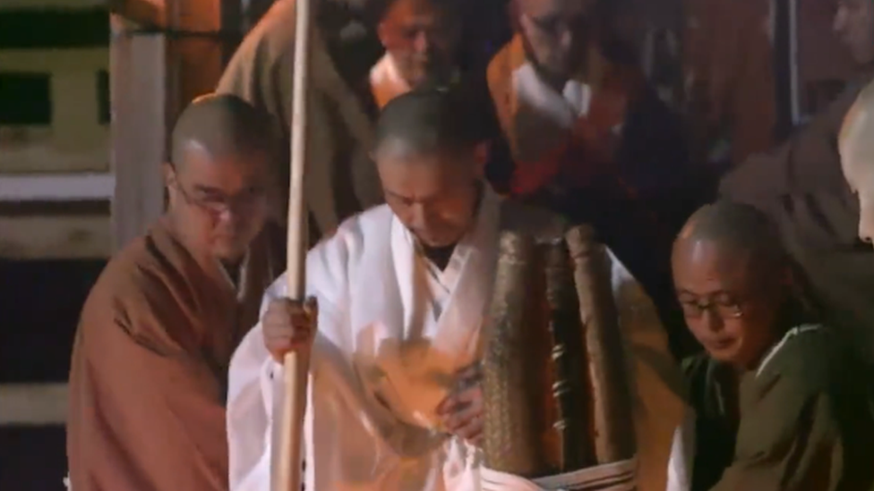 Kogan Kamahori surrounded by other monks as he emerges from the fast